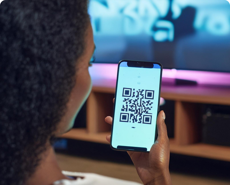 Shopper scanning a QR code on a connected TV screen